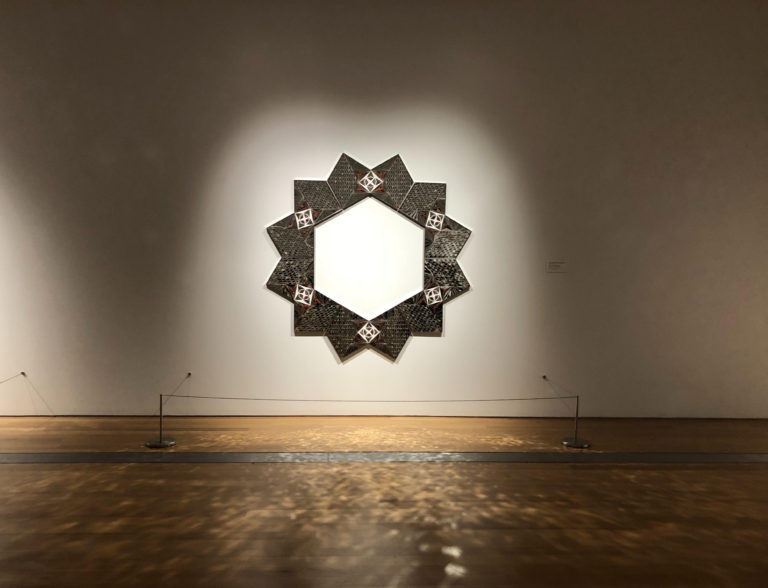 ArtPrize photo of entry from 2018 at Grand Rapids Art Museum in Grand Rapids Michigan of a mosaic light fixture casting light on to wooden floor. It is the main photo for the ArtPRize 2021 Must-See Location article on Lucas Howard Group's website.