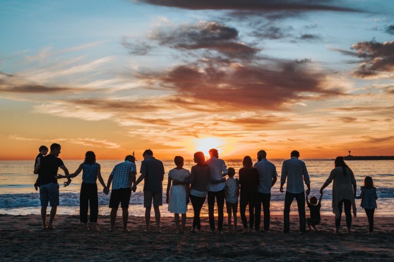 Family holding hands on beach